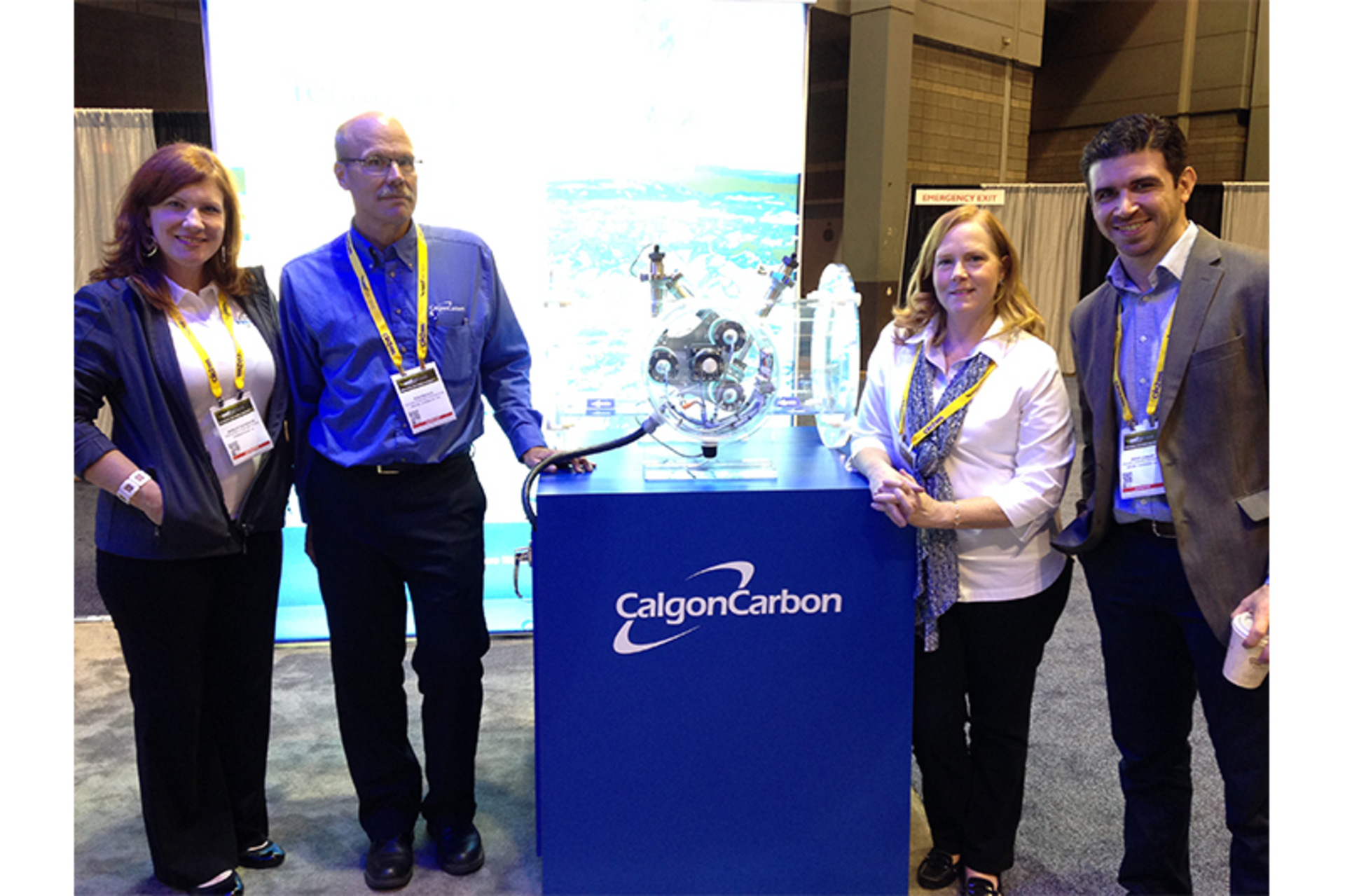 Image 1. The Water Technology and Calgon Carbon teams pose in front of the Calgon booth during WEFTEC 2015.
