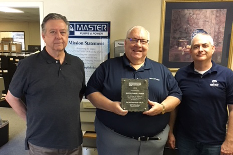 SPX Flow presents Master Pumps & Power with a plaque that celebrated its 50 years of service to North America. Image courtesy of SPX FLOW