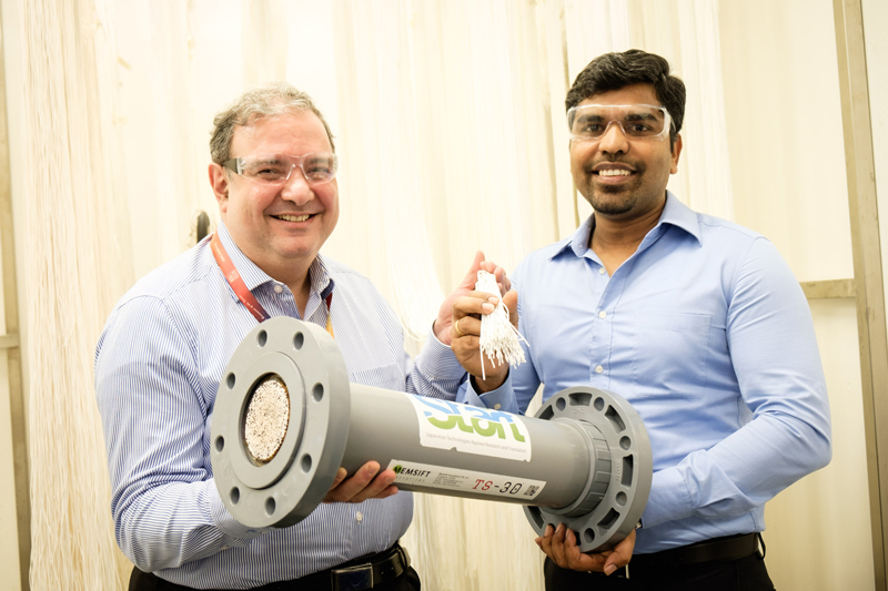 Adil Dhalla (left), Managing Director of START Centre, holds the tri-bore, hollow-fiber membrane with Antony Prince (right), Founder of Memsift Innovations. Courtesy of NTU Singapore
