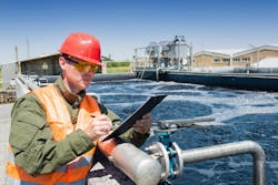 Inspecting water quality in an aerated sludge tank at a municipal wastewater treatment plant Inspecting water quality in an aerated sludge tank at a municipal wastewater treatment plant