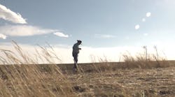 EGE co-founder Marvin Nash stands in a field in Wyoming.