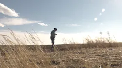 EGE co-founder Marvin Nash stands in a field in Wyoming.