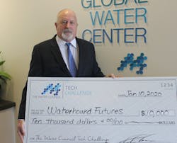 Tony Jones, Ph.D, of Waterhound Futures accepts a check.