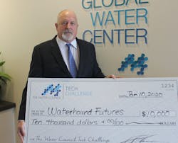 Tony Jones, Ph.D, of Waterhound Futures accepts a check. Tony Jones, Ph.D, of Waterhound Futures accepts a check.