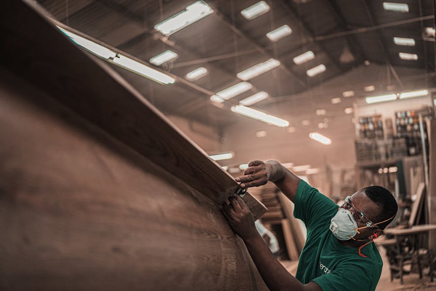 Manufacturing Man In Green T Shirt Holding A Tool 3637829 Pexels