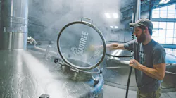 Director of Brewing Operations Matt Rowe sprays out the mash/lauter tun on MadTree’s 126 BBL production brewhouse during a brew day.