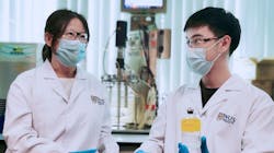 The team led by Associate Professor He Jianzhong (left) and Research Fellow Dr Wang Qingkun (right) discovered Thauera sp. strain SND5 after they isolated and tested various strains of bacteria from wastewater samples. Dr Wang holding a wastewater sample containing the unique SND5 bacterium.