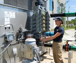 A water service technician checks a factory-equipped water treatment system. A water service technician checks a factory-equipped water treatment system.