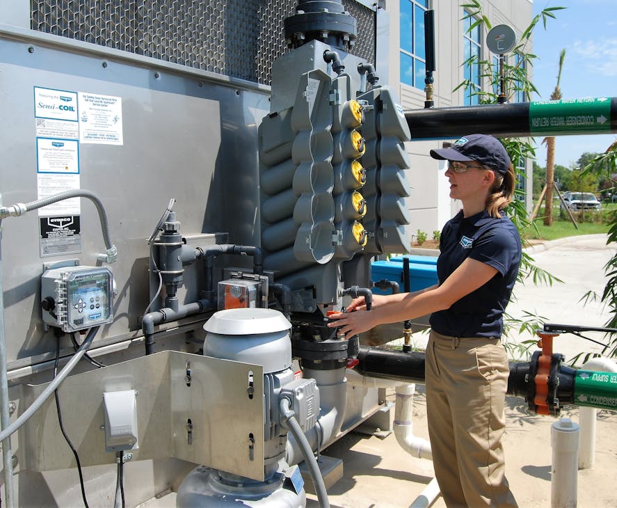 A water service technician checks a factory-equipped water treatment system.