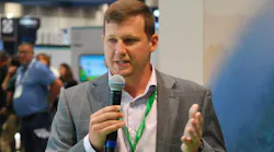 Schneider Electric water and wastewater business development leader Jacob Thompson speaks at the company's booth at WEFTEC 2024 in New Orleans.