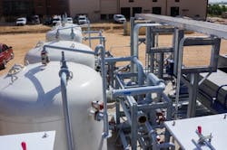 An inclined plate clarifier and auxiliaries. Visible equipment from left to right includes chemical addition and mixing tanks, service water piping, the inclined plate clarifier and the sludge dewatering unit. An inclined plate clarifier and auxiliaries. Visible equipment from left to right includes chemical addition and mixing tanks, service water piping, the inclined plate clarifier and the sludge dewatering unit.