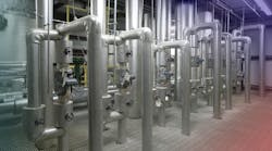 Various metal pipes and shut off valves in water treatment facility Various metal pipes and shut off valves in water treatment facility