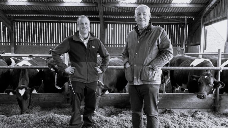 Richard Greaves, farm manager, and Adrian Fenton, managing director, for Yeo Valley Farms Ltd. stand in front of their dairy cows in England.